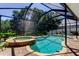 A beautiful screened-in pool and hot tub area, perfect for relaxation and entertaining at 14427 Pepperpine Dr, Tampa, FL 33626
