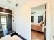 Hallway view of a bedroom and a modern bathroom with a black-tiled shower at 1972 Briarwood St, Dunedin, FL 34698