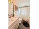 Bathroom showing vanity with bronze fixtures, toilet, and shower featuring patterned curtain at 1972 Briarwood St, Dunedin, FL 34698