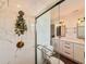 Bathroom showing modern walk-in shower with rainfall showerhead and gold fixtures, toilet, and vanity at 1972 Briarwood St, Dunedin, FL 34698