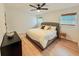 Charming bedroom featuring a comfortable queen bed, hardwood floors, and natural light at 1972 Briarwood St, Dunedin, FL 34698