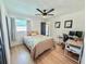 Comfortable bedroom featuring a ceiling fan, neutral tones, and two desk spaces at 1972 Briarwood St, Dunedin, FL 34698