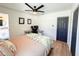 Cozy bedroom with a ceiling fan, a view to the bathroom and a workspace at 1972 Briarwood St, Dunedin, FL 34698
