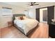 Relaxing bedroom boasts a large bed, hardwood floors, and natural light from two windows at 1972 Briarwood St, Dunedin, FL 34698