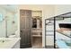 Bathroom showcasing a view of the closet entrance, featuring a shelving unit and organized storage at 1972 Briarwood St, Dunedin, FL 34698