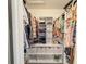 Walk-in closet featuring built-in shelves, storage cubes, and hanging racks for organized clothing and accessories at 1972 Briarwood St, Dunedin, FL 34698