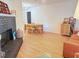 Open-concept living area with modern lighting, fireplace and dining table set at 1972 Briarwood St, Dunedin, FL 34698