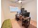 Office space featuring a desk with computer monitors, rolling chair, and natural lighting at 1972 Briarwood St, Dunedin, FL 34698