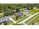 Aerial view of home with fenced yard, mature trees, neighborhood sidewalks, and proximity to local road at 22431 Panther Run Ct, Land O Lakes, FL 34639