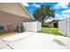 Spacious concrete patio with a large green tree and shed for storage at 22431 Panther Run Ct, Land O Lakes, FL 34639