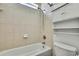 Bathtub and shower combo with a white shower head and a storage space at 22431 Panther Run Ct, Land O Lakes, FL 34639
