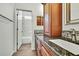 A bathroom with white tiled walls, a bathtub with a shower, and storage at 22431 Panther Run Ct, Land O Lakes, FL 34639
