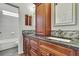 Bathroom featuring dual sinks with granite counters and tile backsplash at 22431 Panther Run Ct, Land O Lakes, FL 34639
