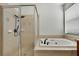 Bathroom featuring tiled shower, soaking tub, and natural light from a window at 22431 Panther Run Ct, Land O Lakes, FL 34639