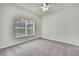 Bright bedroom with ceiling fan and window, carpeted floor, neutral paint color at 22431 Panther Run Ct, Land O Lakes, FL 34639