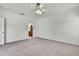Bedroom featuring carpeted floors, a ceiling fan, and an entrance to an ensuite bathroom at 22431 Panther Run Ct, Land O Lakes, FL 34639