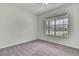 A well-lit room with a large window, neutral carpeting and a ceiling fan at 22431 Panther Run Ct, Land O Lakes, FL 34639