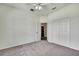 Carpeted empty bedroom with neutral walls, a double closet, and a ceiling fan at 22431 Panther Run Ct, Land O Lakes, FL 34639