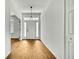 Bright foyer featuring wood-look tile flooring, a modern light fixture and a view of the front door at 22431 Panther Run Ct, Land O Lakes, FL 34639