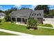Landscaped front yard featuring a well-maintained lawn and mature trees at 22431 Panther Run Ct, Land O Lakes, FL 34639