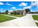 Exterior home view with a driveway leading to a two-car garage and well-maintained landscaping at 22431 Panther Run Ct, Land O Lakes, FL 34639