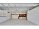 Spacious garage with a window and wooden shelving for storage at 22431 Panther Run Ct, Land O Lakes, FL 34639