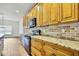 Well-appointed kitchen featuring granite counters, brick backsplash, and modern appliances at 22431 Panther Run Ct, Land O Lakes, FL 34639