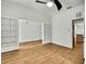 Living room with wood-look tile floors and glass paneled doors leading to a bedroom at 22431 Panther Run Ct, Land O Lakes, FL 34639