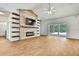 Spacious living room with a stacked stone fireplace, floating shelves, and sliding glass doors to the outside at 22431 Panther Run Ct, Land O Lakes, FL 34639
