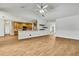 Bright, open-concept living room with a view of the kitchen, featuring wood-look tile flooring at 22431 Panther Run Ct, Land O Lakes, FL 34639