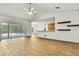 Inviting open-concept living space with a kitchen view, sliding glass doors to the pool and tile flooring at 22431 Panther Run Ct, Land O Lakes, FL 34639