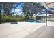 Inviting screened pool featuring a built-in hot tub, with views of the spacious, green backyard area at 22431 Panther Run Ct, Land O Lakes, FL 34639