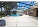 Beautiful screened pool with a built-in hot tub and lush greenery creates a serene backyard oasis at 22431 Panther Run Ct, Land O Lakes, FL 34639