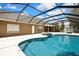 Relaxing screened pool area with hot tub, ample deck space, and a beautiful backyard view, perfect for outdoor enjoyment at 22431 Panther Run Ct, Land O Lakes, FL 34639