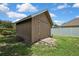 Wood shed exterior with a simple door, great for storage at 22431 Panther Run Ct, Land O Lakes, FL 34639