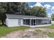A screened-in patio is the highlight of the backyard, providing a perfect space for entertaining and enjoying the outdoors at 22716 Penny Loop, Land O Lakes, FL 34639