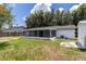 Backyard view showcases a spacious yard and a large screened-in patio for outdoor enjoyment at 22716 Penny Loop, Land O Lakes, FL 34639