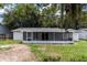 Spacious backyard with a screened-in patio, offering plenty of room for outdoor activities and relaxation at 22716 Penny Loop, Land O Lakes, FL 34639