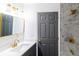 Modern bathroom with a gray vanity, quartz countertop, and a tiled shower with gold hardware at 22716 Penny Loop, Land O Lakes, FL 34639