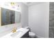 Modern bathroom with a quartz countertop, gold faucet, vanity mirror and shower at 22716 Penny Loop, Land O Lakes, FL 34639