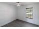 Bright bedroom with hardwood floors, ceiling fan and a window view of the outdoors at 22716 Penny Loop, Land O Lakes, FL 34639