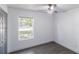Bright bedroom with hardwood floors, ceiling fan and window view of the neighborhood at 22716 Penny Loop, Land O Lakes, FL 34639