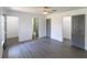 Spacious primary bedroom with wood-look flooring and ensuite access to the bathroom and closet at 22716 Penny Loop, Land O Lakes, FL 34639