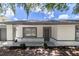 Home's facade showcasing a gray front door, manicured landscaping, and fresh exterior paint at 22716 Penny Loop, Land O Lakes, FL 34639