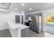 Kitchen featuring gray cabinets, stainless appliances, quartz counters and breakfast bar seating at 22716 Penny Loop, Land O Lakes, FL 34639
