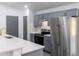 Stylish kitchen with gray cabinets, stainless steel appliances, and quartz countertops at 22716 Penny Loop, Land O Lakes, FL 34639