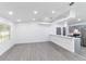 Spacious living area featuring hardwood floors, abundant natural light, modern lighting, and an open floorplan at 22716 Penny Loop, Land O Lakes, FL 34639