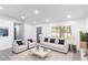 Bright living room with a white sofa, armchairs, and a cozy rug at 22716 Penny Loop, Land O Lakes, FL 34639