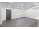 Open-concept living space with hardwood floors, freshly painted walls, and an abundance of natural light at 22716 Penny Loop, Land O Lakes, FL 34639