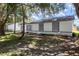 Home exterior with trees, fresh exterior paint, and landscaping at 22716 Penny Loop, Land O Lakes, FL 34639